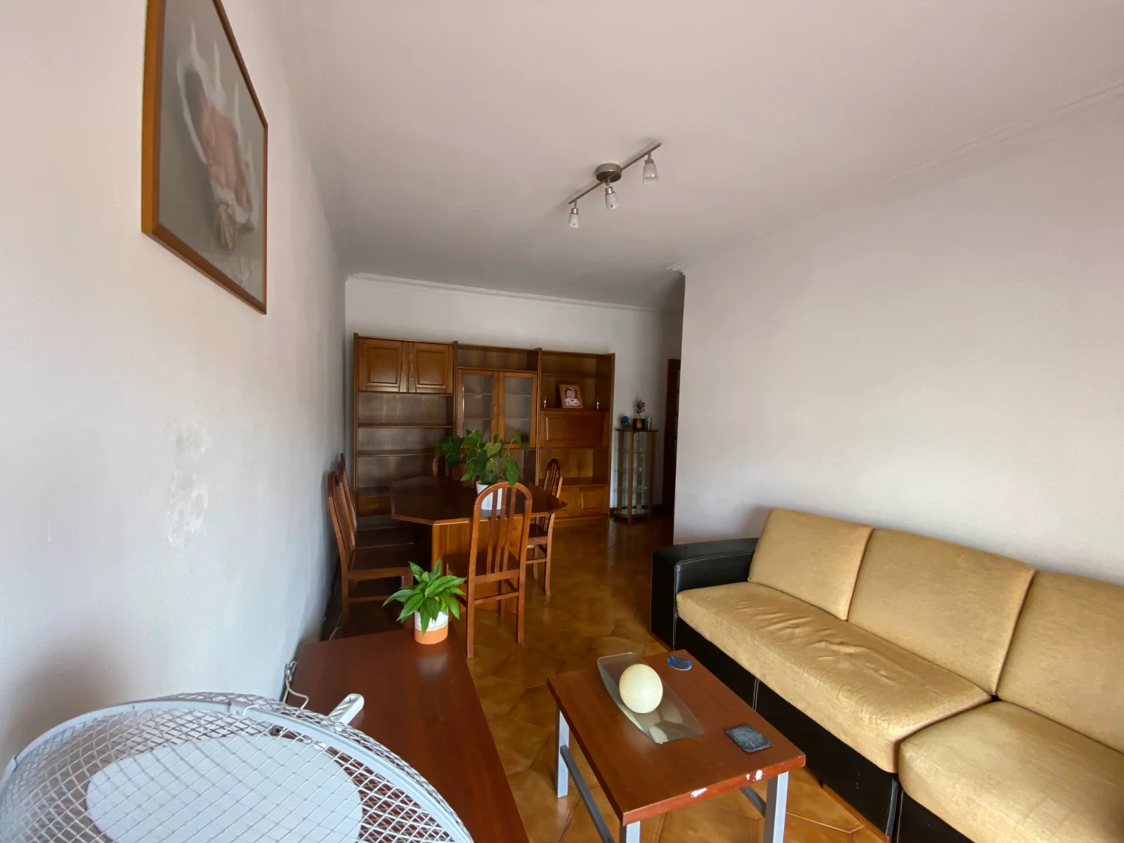 Sala antes da transformação: móveis antigos e paredes gastas